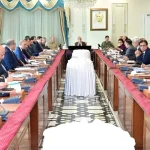 Government officials and ministers seated around a long conference table in Islamabad, discussing the extension of austerity measures and revised business hours until June 30, 2026.